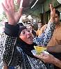 palestinianwomanreceivesfreesweetsfromavendorasaformofcelebration.jpg